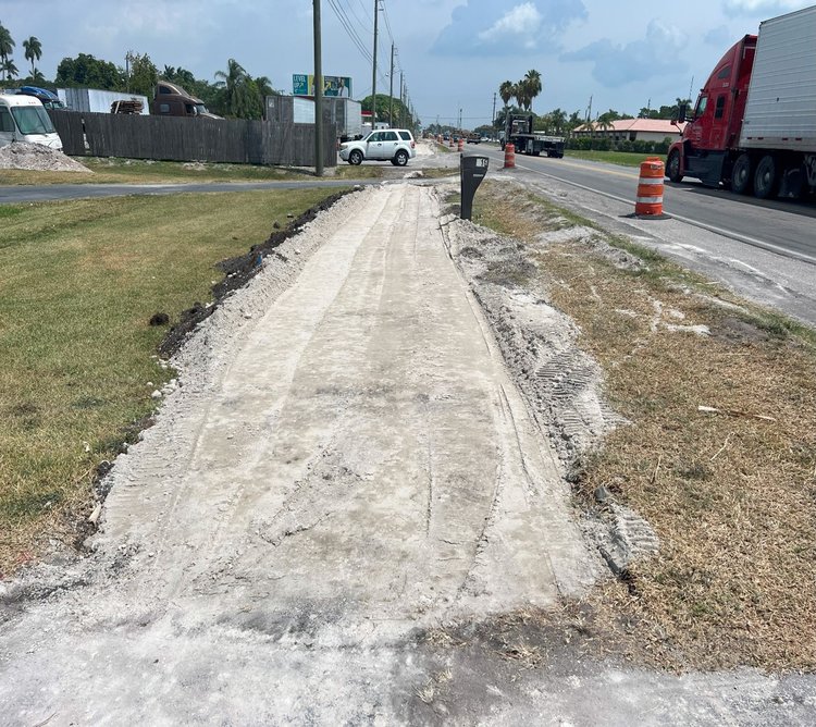 Lime rock base placement at new sidewalk construction along the west side of SR 715   May 2024