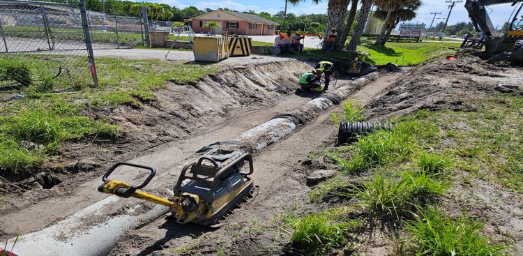Installing side drain SD 101 to SD 102, north side looking east, June 2024