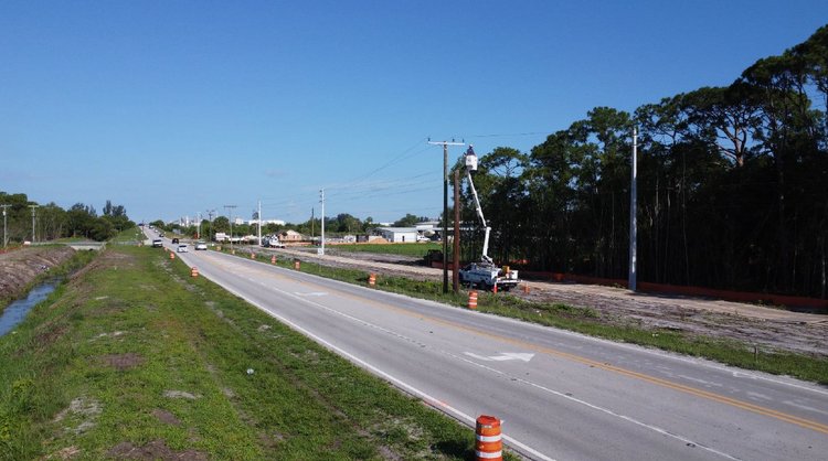FPL subcontractor Pike Construction, relocating power lines from existing to new poles, looking west, July 2024
