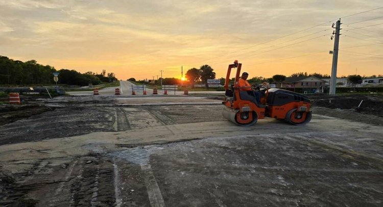 Placing temporary asphalt patch across Midway Road, facing west, Sept. 2024