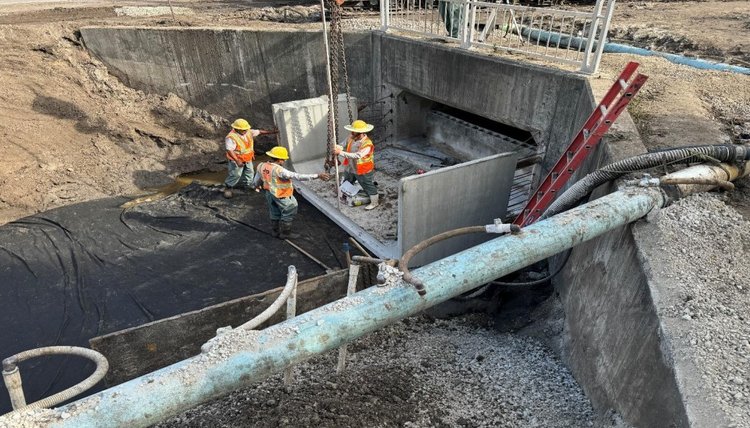 Installing first precast box culvert segment in preparation for closure pour, Nov. 2024