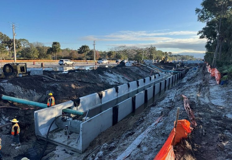 Canal bypass pipe at left through proposed drainage opening preparing to discharge, Jan. 2025