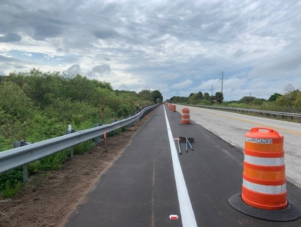 Northbound SR 710 Warfield Blvd. installation of drop off material after shoulder paving, Mar. 2024