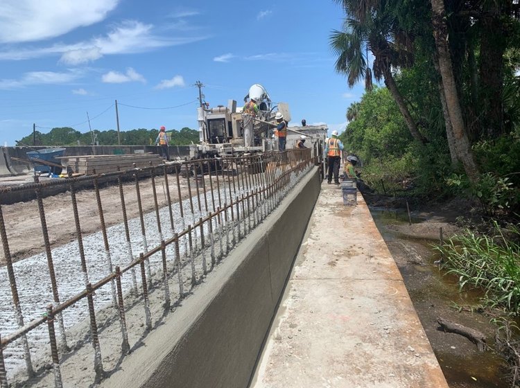 Concrete slipform operation for class II conctrete pour on concrete barrier wall coping junction slab located on SR 710  Warfield Blvd at SW Tommy Clements Street, August. 2024